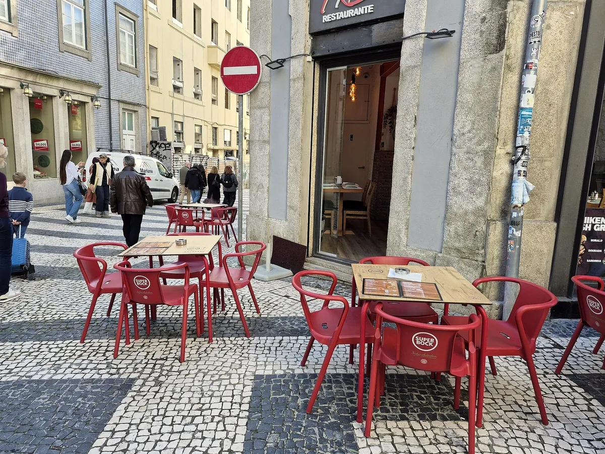 Café chairs on a cobbled pavement in central Porto