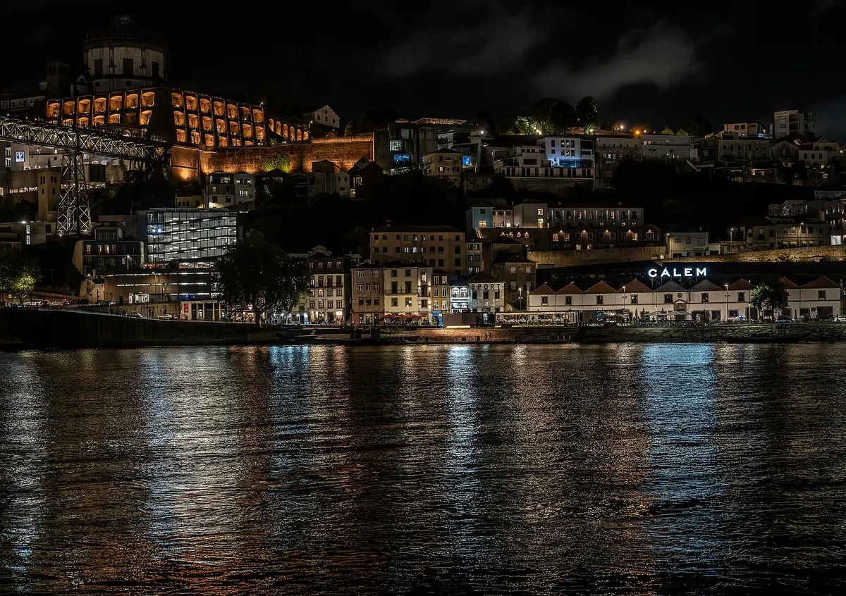 Ribeira's lights reflected across the Douro at night
